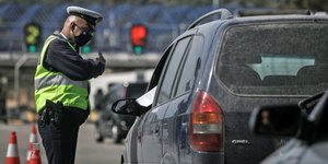 Αστυνομικός στα διόδια ελέγχει αυτοκίνητο που φεύγει από την Αθήνα