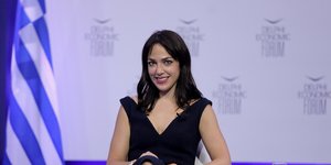 Δόμνα Μιχαηλίδου καθιστή χαμογελά