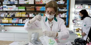 Γυναίκα φαρμακοποιός βάζει self test σε σακούλα
