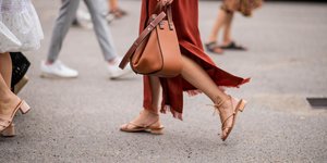 γυναίκα με σανδάλια και φούστα