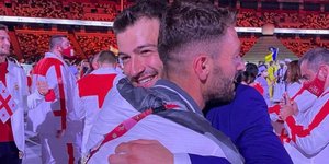 αδέλφια από Συρία αγκαλιάζοντα σε έναρκη σε Ολυμπιακούς Αγώνες στο Τόκιο