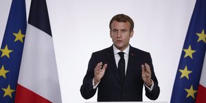 O πρόεδρος της Γαλλίας, Εμανουέλ Μακρόν με φόντο τις σημαίες της Γαλλίας και της ΕΕ 