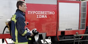 Πυροσβέστης μπροστά σε όχημα