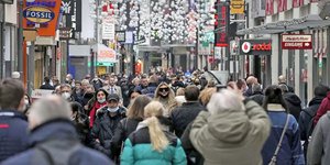 Πολίτες με μάσκες και χωρίς σε εμπορικό πεζόδρομο στην Κολωνία