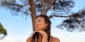 Η Ρωσίδα infuencer Alina Yoga ποζάρει μπροστά από ένα δέντρο