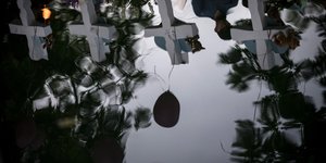 Σταυροί και μπαλόνια αντικατοπτρίζονται στο σιντριβάνι της πλατείας της Ουβάλδε