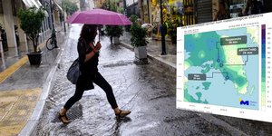 Γυναίκα με ομπρέλλα στην ισχυρή βροχή που έπληξε την Αθήνα 