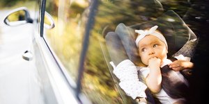 Μικρό μωρό δεμένο με ζώνη ασφαλείας σε κάθισμα αυτοκινήτου