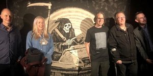 Το συγκρότημα με τον πίνακα του Banksy