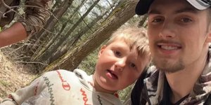 Το οκτάχρονο αγόρι με έναν από τους διασώστες του 