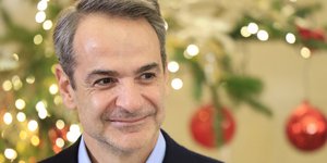 Ο Κυριάκος Μητσοτάκης μπροστά από χριστουγεννιάτικο δένδρο
