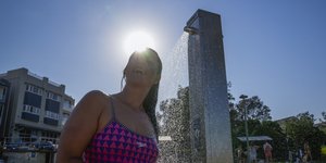 Γυναίκα δροσίζεται στο κύμα καύσωνα που πλήττει την Αυστραλία 