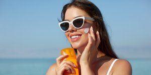 Κοπέλα βάζει αντηλιακό στο πρόσωπό της