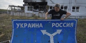 Ανδρας κρατάει πινακίδα κατεύθυνσης