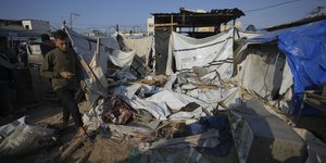 Παλαιστίνιος κοιτάζει το κινητό του ανάμεσα σε συντρίμμια