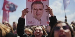 Διαδηλώτρια κρατά στα χέρια της φωτογραφία του φυλακισμένου Εκρέμ Ιμάμογλου