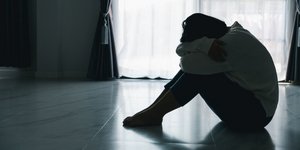 Θλιμμένη γυναίκα στο πάτωμα