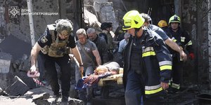 Διασώστες μεταφέρουν τραυματία από ρωσικό χτύπημα στο Ντνίπρο της Ουκρανίας