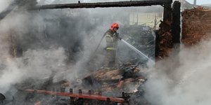 Πυροσβέστης σβήνει φωτιά σε κτίριο που βομβαρδίστηκε στην Ουκρανία