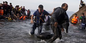 Migrants and refugees arrive on a dinghy
