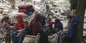 Γυναίκες και παιδιά στα ερείπια σπιτιού μετά τον φονικό σεισμό στο Αφγανιστάν