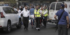 Israeli Zaka rescue and recovery team carry the body of a victim at the scene of shooting attack carried out by two Palestinian gunmen