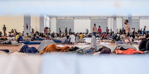 migrants at an overcrowded reception site in Agia, Crete