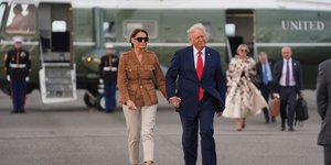 President Donald Trump and first lady Melania Trump walk after arriving on Marine One at Stansted Airport, Thursday, Sept. 18, 2025, in Stansted, England