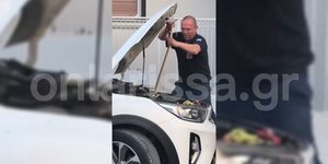 Πυροσβέστης απομακρύνει το φίδι από μηχανή αυτοκινήτου