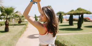 νεαρή γυναίκα ποζάρει πλάτη σε εξωτερικό χώρο