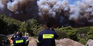 Πυροσβέστες παρατηρούν τη φωτιά στο Πόρτο Γερμενό