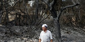 Eνας κάτοικος στο καμένο δάσος στο Μάτι-Φωτογραφία: AP/Τhanassis Stavrakis