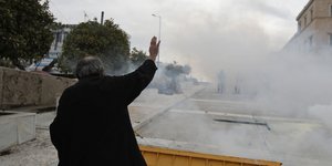 Ρασοφόρος τα βάζει με τα δακρυγόνα/ Φωτογραφία: AP- Thanassis Stavrakis